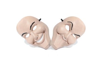 Two funny plastic masks with two faces and two emotions on a white background.