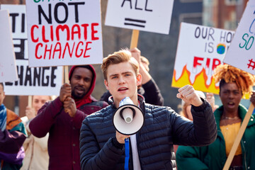 Group Of Protestors With Placards And Megaphone On Demonstration March Against Climate Chane