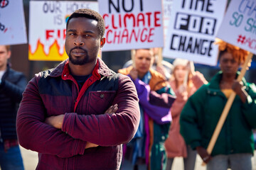 Group Of Protestors With Placards On Demonstration March Against Climate Chane