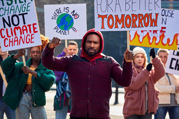 Group Of Protestors With Placards On Demonstration March Against Climate Chane