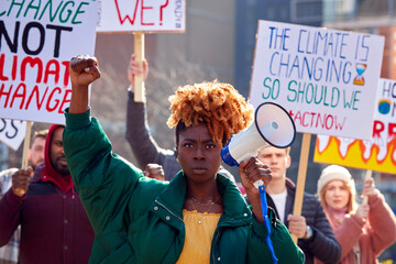 Group Of Protestors With Placards And Megaphone On Demonstration March Against Climate Chane