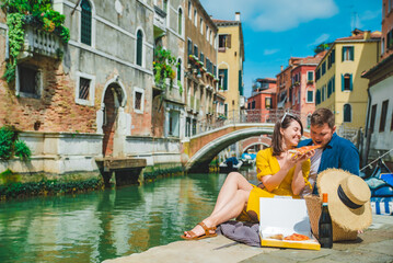 Fototapeta na wymiar couple having date at pier with beautiful view of venice canal