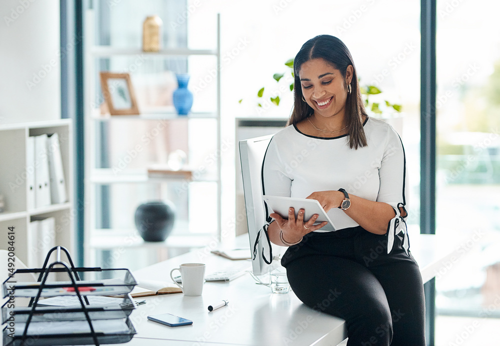 Aufkleber doing business with just a few touches. shot of a young businesswoman using a digital tablet in an o