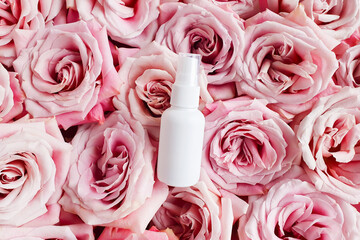 White cosmetic spray bottle on pink roses flower texture background. Mockup. Skincare beauty and liquid antibacterial spray. Natural Body mist. Front view, flat lay. Bottle for branding - Powered by Adobe