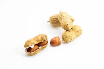 Unpeeled and peeled peanuts isolated on white background. Top view.
