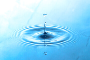 A drop of water in the shape of a heart.Splash on the water.