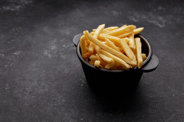 French fries on a dark background, with space for text