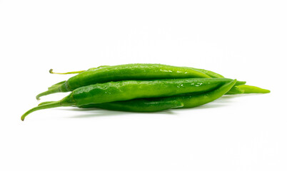 green chili pepper slices isolated on wooden background with clipping path
