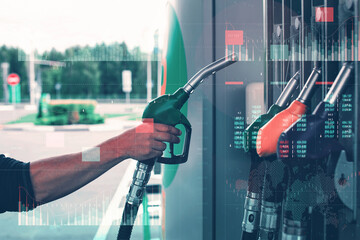 A man fills up a car at a gas station on technological background. Graph of rising prices for...