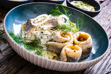Swedish style marinated herring fillets in mayonnaise and cream with pickled cucumber, parsley,...