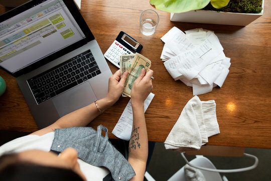View from above waitress counting tips in restaurant