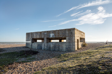 Fototapeta na wymiar Second world war pillbox on Rye Harbour beach, East Sussex, England, on a sunny winter day