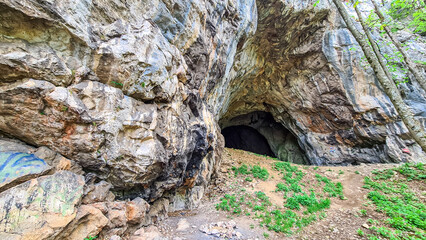 View on the entrance of the Drachenhoehle (Dragon Cave) in Pernegg an der Mur in Styria, Austria. Cave near mount Rothelstein in Mixnitz in the Grazer Bergland. Grotto, Europe. Hiking trail.