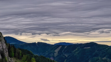 Mystical clouds and scenic view from mount Roethelstein near Mixnitz in Styria, Austria. Landscape of green alpine meadow and bushes in the valley of Grazer Bergland in Styria, Austria. Cloudscape