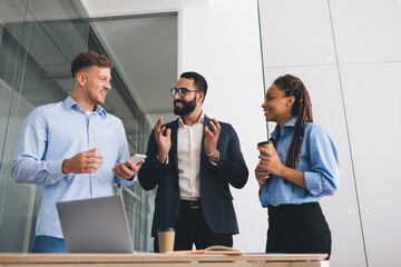 Corporate group of cheerful professional employees discussing strategy planning during involved...