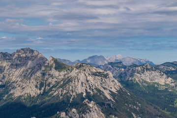 Panoramic view from Messnerin on the alpine mountain chains in Styria, Austria, Hochschwab region. Hills overgrown with small bushes, higher parts rocky and bare. Summer day. Hiking in Alps, Tragoess