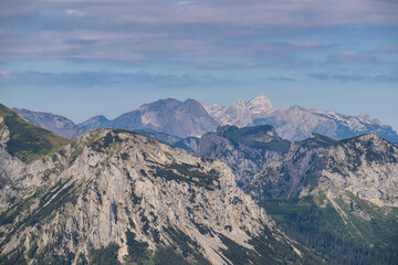 Panoramic view from Messnerin on Hochtor and alpine mountain chains in Styria, Austria, Hochschwab region. Hills overgrown with bushes, higher parts rocky. Summer day. Hiking in Alps, Tragoess