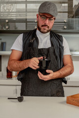 Coffee shop employee (barista) prepare a coffee cup whit a italian coffee maker