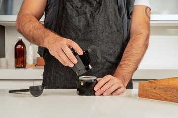 Man coffee barista preparing coffee at an italian maker machine in a coffee shop