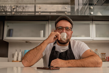 Coffee shop owner drinks a cup of espresso waiting to take an order