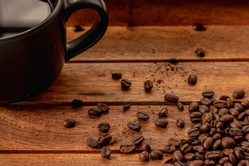 close up of a coffee cup and beans in wood tray