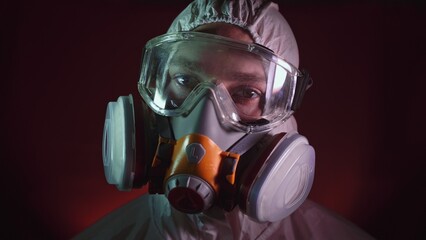 Man in protective costume suit, gas protect medical antibacterial antiviral spray paint mask....