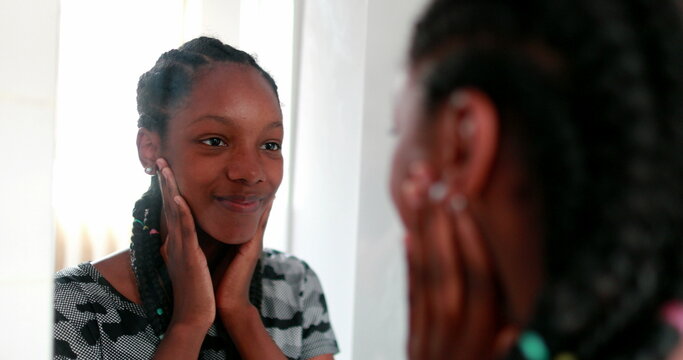 Confident Black Teen Girl Looking At Herself In In Mirror