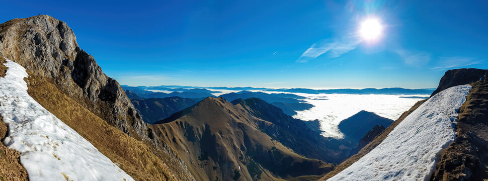 A panoramic view on mount Eisenerzer Reichenstein (2165m) near Eisenerz in Styria, Austria, Europe. Austrian Alps. The Ennstal valley is covered in clouds and fog. Hiking trail,Wanderlust. Sunny day