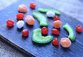 multi-colored dried fruits cherry pomelo on a dark background
