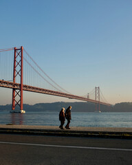 Old people walk along the river, Lisbon  - obrazy, fototapety, plakaty