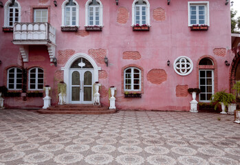 Fototapeta na wymiar House with pink walls, windows, a very colorful model house in Verona, Italy.