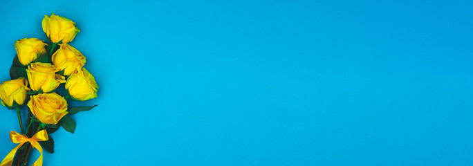 Beautiful abstract pattern with yellow roses on blue background. Nature background.  Nature background. Minimal floral card. Floral pattern.