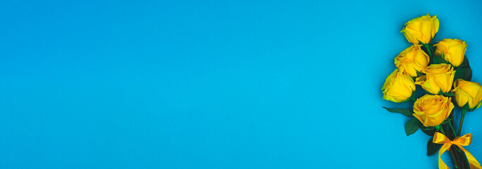 Beautiful abstract pattern with yellow roses on blue background. Nature background.  Nature background. Minimal floral card. Floral pattern.