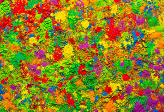 Happy Holi. Colorful background of multicolored gulal powder paints. A colorful festival of colored paints made from powder and dust. Celebration of bright colors of Indian tradition.