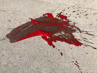 Pool of blood (tomato juice) on asphalt - 492102695