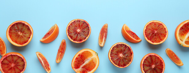 Many ripe sicilian oranges on light blue background, flat lay with space for text. Banner design