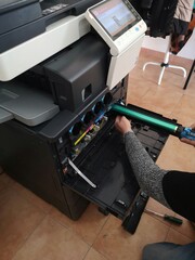technician does maintenance on professional color multifunction