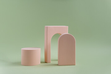 Beige geometric shapes on a green dull background with space for text and design. Minimalistic...