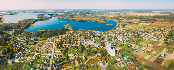 Slobodka, Braslaw District, Vitebsk Voblast, Belarus. Aerial View Of Potsekh Lake Near Slobodka Village. Church of Divine Providence. Panorama. - obrazy, fototapety, plakaty