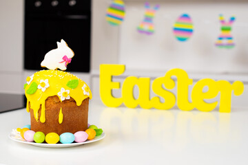 Easter cake with a rabbit and painted eggs on the table. Religious holiday