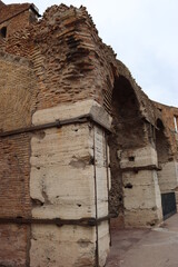 ROME, ITALY - February 05, 2022: Panoramic view of inside part of Colosseum in city of Rome, Italy. Cold and gray sky in the background. Macro photography of the arches.