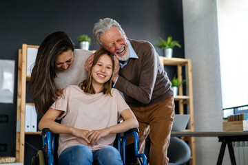 Happy multiethnic family with child with disability in wheelchair