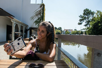 Young girl taking a selfie with smartphone
