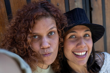 Two adult Latin American women (34 and 29), both with green eyes and positive attitude have fun...