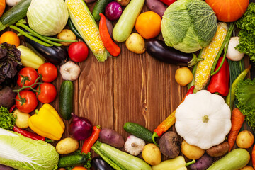 Top view of various vegetables on a wooden table with copy space. Concept of healthy food. Organic vegetables on wooden background