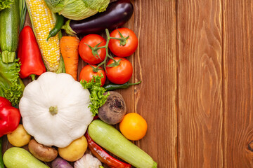 Top view of various vegetables on a wooden table with copy space. Concept of healthy food. Organic vegetables on wooden background