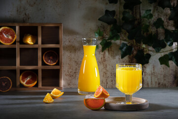 Glass of fresh orange juice with fresh fruit on a wooden table Still life with fresh orange juice...