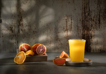 Glass of fresh orange juice with fresh fruit on a wooden table Still life with fresh orange juice...