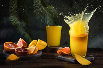 Glass of fresh orange juice with fresh fruit on a wooden table Still life with fresh orange juice...