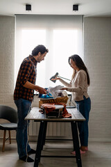 Young couple at home doing household chores and ironing together